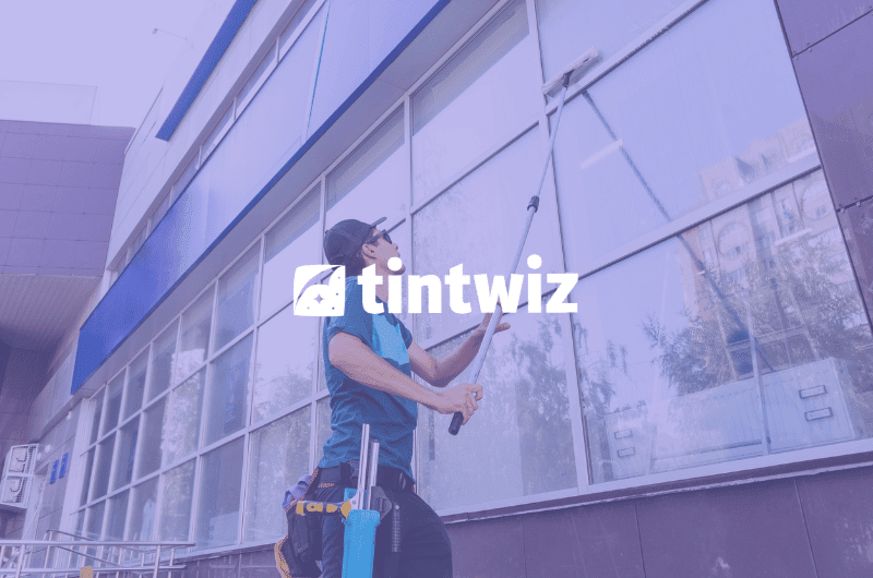 Professional window cleaner washing commercial windows