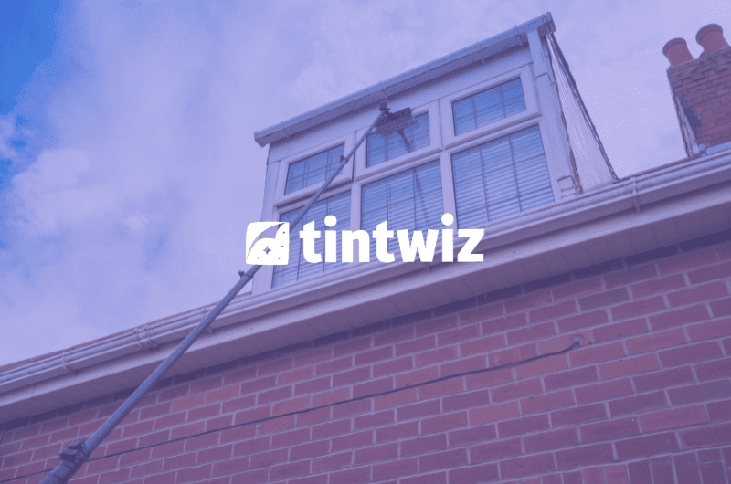 Professional window cleaner cleaning residential windows