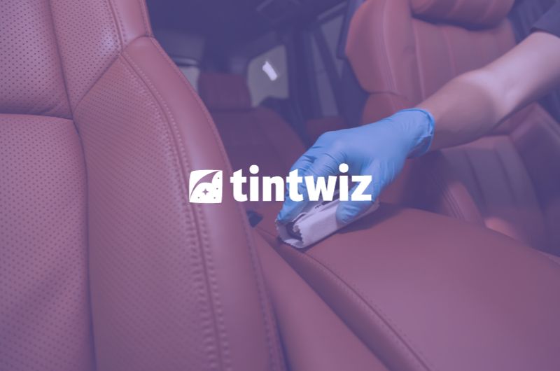 Professional applying ceramic coating on a car using Tint Wiz CRM software management